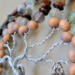 wood beads strung on silver color wire twisted into branches of the tree
